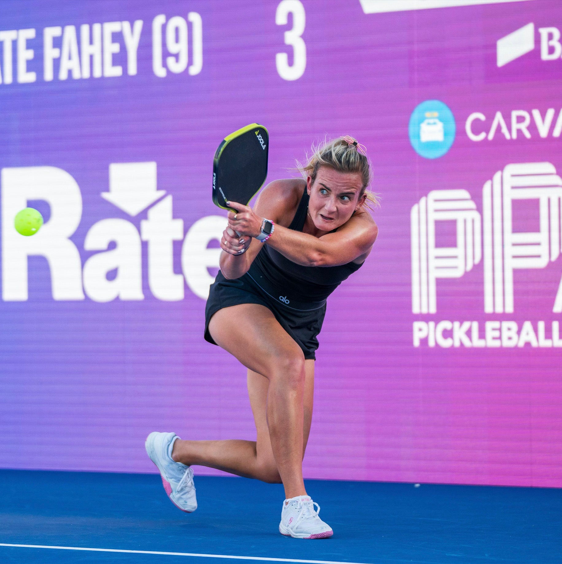 Stylish pickleball shoes for women. Kate Fahey wearing Montis pickleball shoes for women in white and pink.