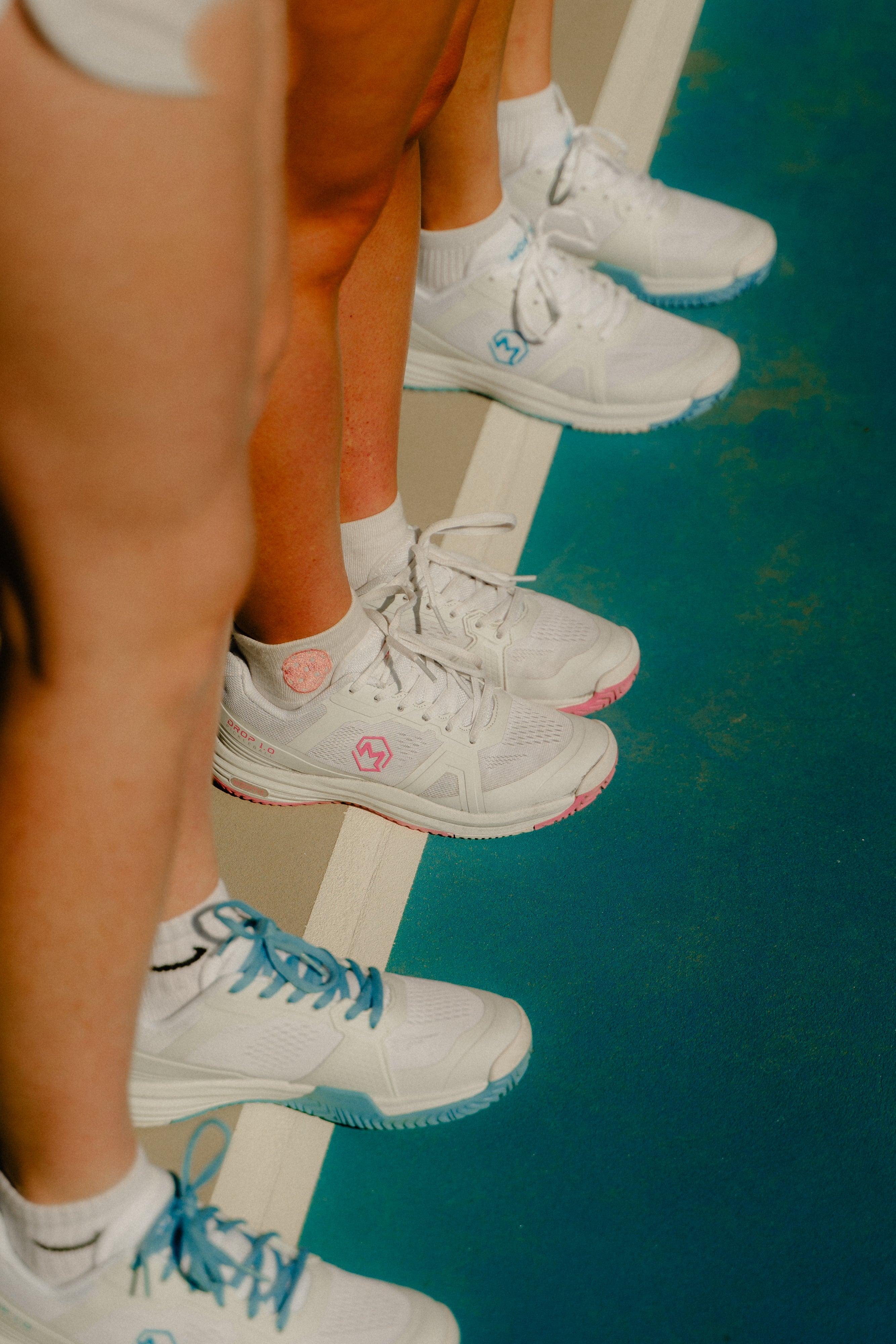 Montis pickleball shoes for women in white and blue and white and pink.
